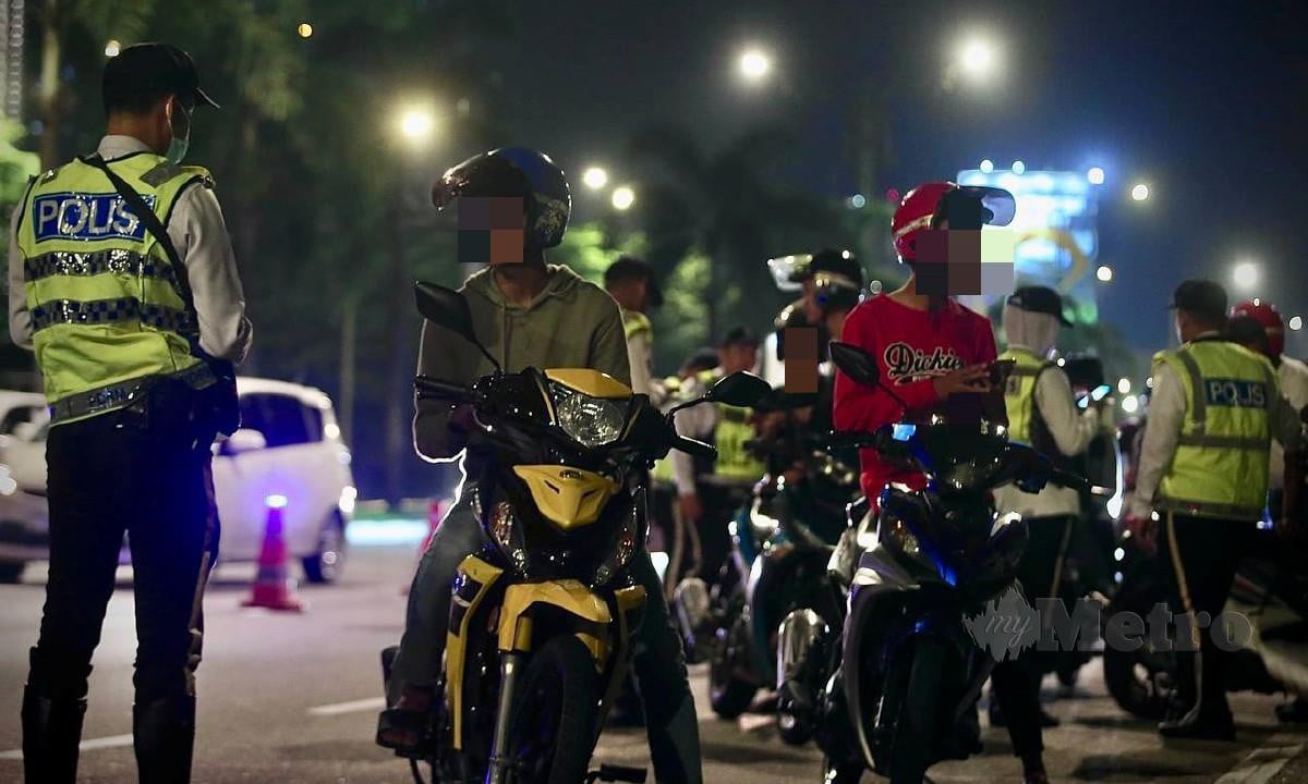 Anggota Polis Trafik Kuala Lumpur menahan penunggang motorsikal dan kenderaan pada Ops Khas Malam Ampang Tahun Baru 2023 di Jalan Loke Yew, Kuala Lumpur. FOTO AZHAR RAMLI