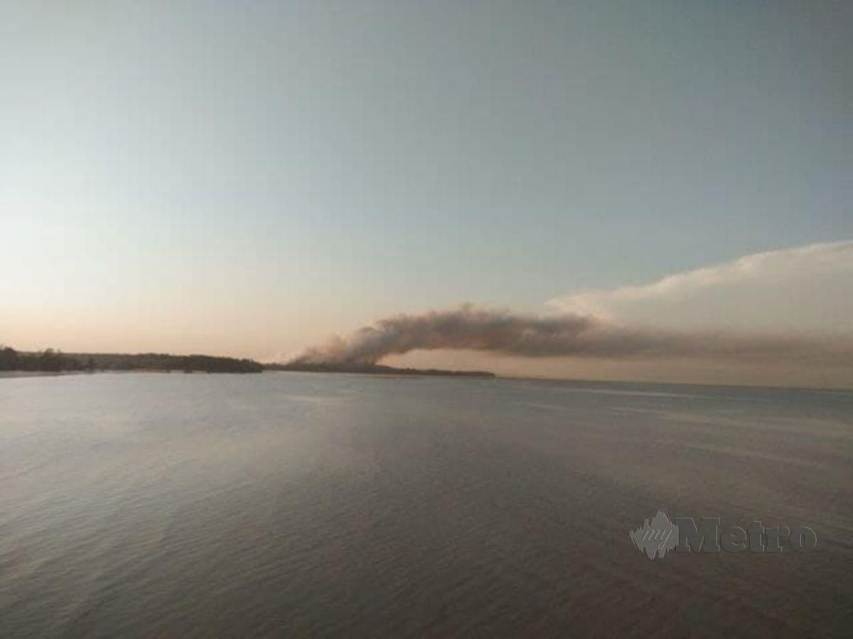 Kepulan asap kebakaran tapak pelupusan sampah Pulau Burung, di sini, sejak Rabu lalu, yang boleh dilihat dari atas Jambatan Kedua Pulau Pinang. FOTO IHSAN SAM