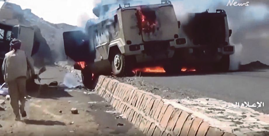 KENDERAAN berperisai  dengan lambang Arab Saudi terbakar diserang pemberontak Houthi.