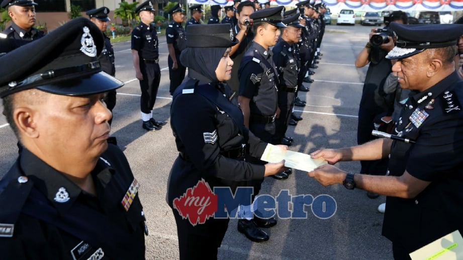 DATUK Mohd Khalil Kader Mohd (kanan) menyampaikan sijil perhargaan kepada anggota polis, pada majlis Perhimpunan Bulanan Febrauri 2018, di dataran kawat PSP Ibu Pejabat Polis Kontinjen (IPK) Johor Bahru. FOTO Mohd Azren Jamaludin