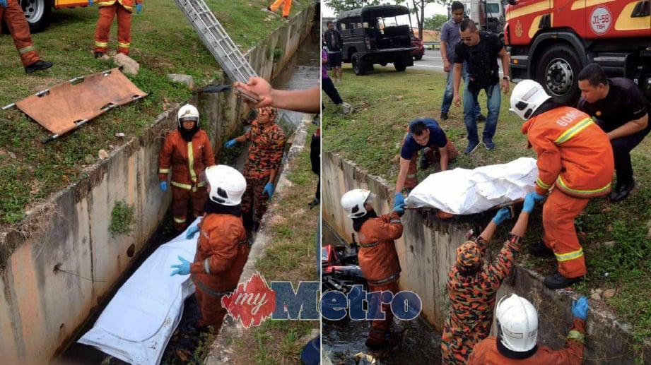 ANGGOTA Bomba membantu mengeluarkan mayat mangsa yang ditemui maut dipercayai terbabas di dalam sebuah longkang di Kilometer 19 Lebuhraya Pasir Gudang menghala ke Pasir Gudang. FOTO Ihsan Bomba