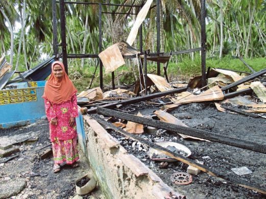 SITI Maryuni  melihat tapak rumah pusakanya yang musnah dijilat api. 