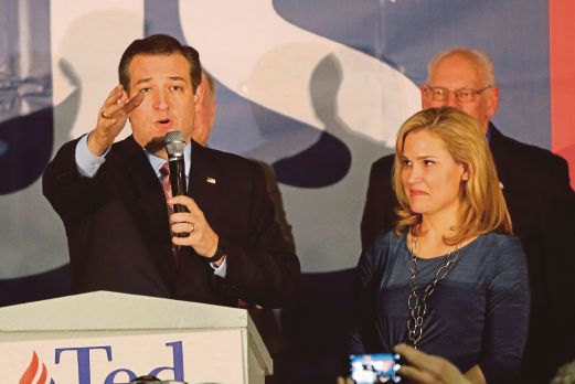 CRUZ berucap kepada penyokongnya sementara diapit isterinya, Heidi, selepas diumumkan menang dalam pemilihan Parti Republikan di Iowa, Des Moines, Iowa, semalam. 