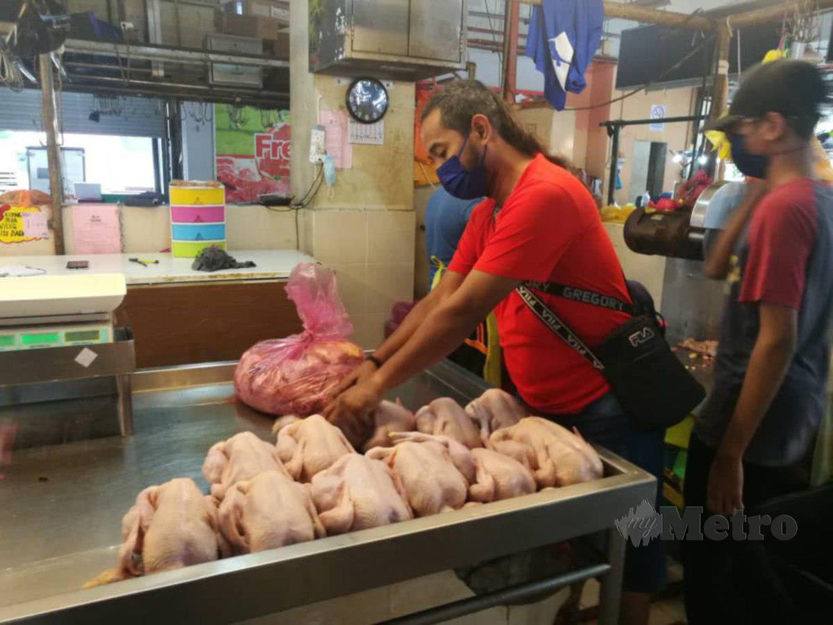 Yusof Md. Yunos menyusun baki ayam untuk dijual.  FOTO OMAR AHMAD
