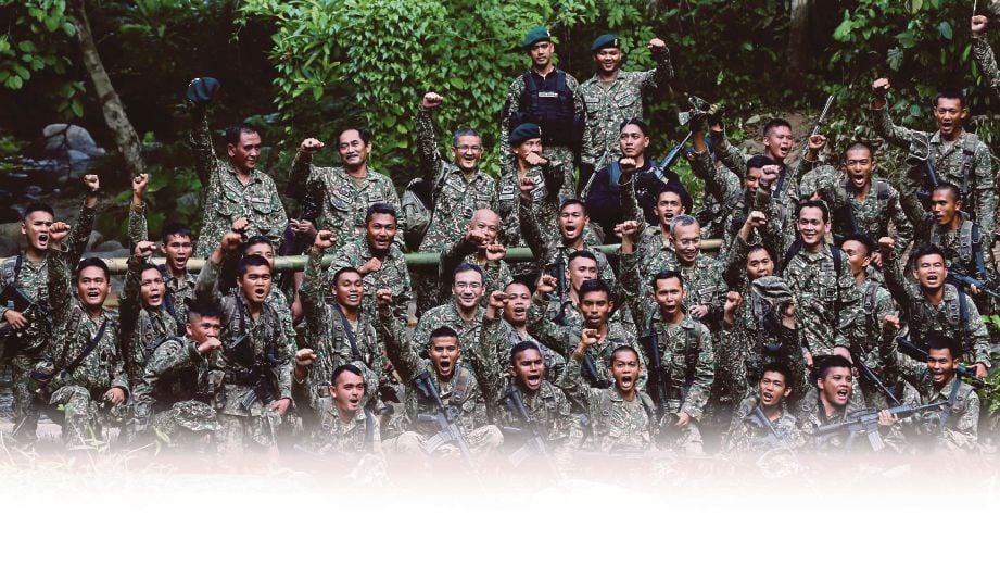  MENTERI Pertahanan, Datuk Seri Hishammuddin Hussein (tengah) bergambar dengan anggota tentera yang bertugas di Kem Marker November, Gerik, Perak.