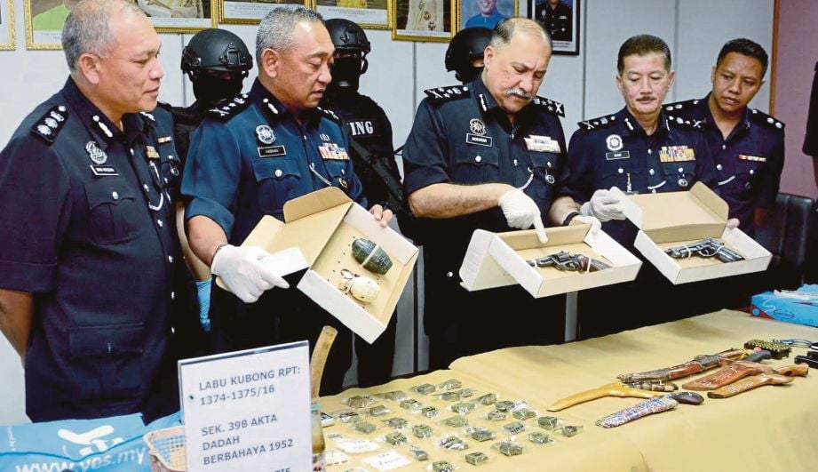MOHD Mokhtar (tengah) menunjukkan pelbagai jenis senjata yang dirampas ketika sidang media di Ibu Pejabat Polis Daerah Hilir Perak.