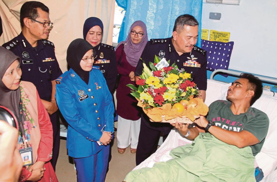   Roslee   memberikan sumbangan kepada Syed Mohamad Farli   di Hospital Kepala Batas, Pulau Pinang. 