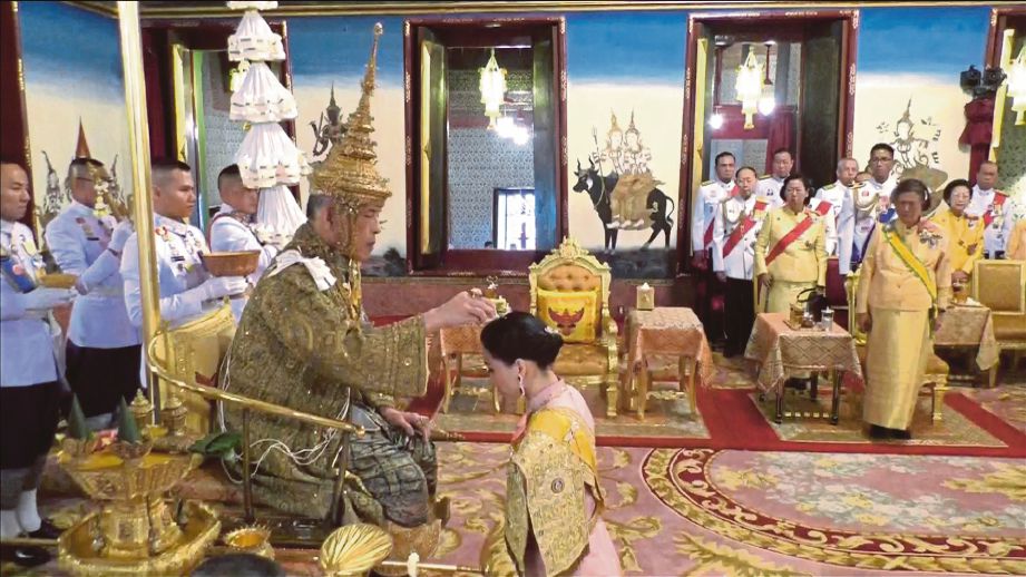 PERMAISURI Suthida berlutut di hadapan Raja Maha Vajiralongkorn ketika majlis  pertabalan, semalam. FOTO Reuters