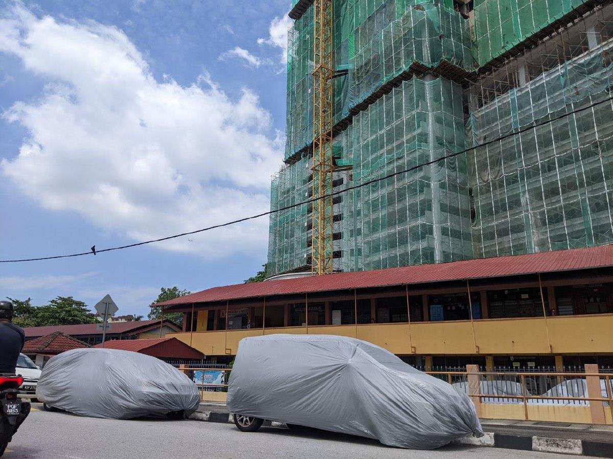 Beberapa kenderaan penduduk di Jalan Sultan Azlan Shah, Kampung Sungai Nibong, di sini, ditutup dengan kain kanvas bagi mengelakkan sisa dari tapak pembinaan seperti habuk dan bancuhan simen mengenai kenderaan. FOTO ZUHAINY ZULKIFFLI