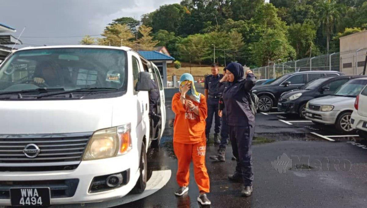 Suri rumah yang membuat laporan polis palsu dibawa ke Mahkamah Majistret Kuala PilahFOTO ABNOR HAMIZAM ABD MANAP