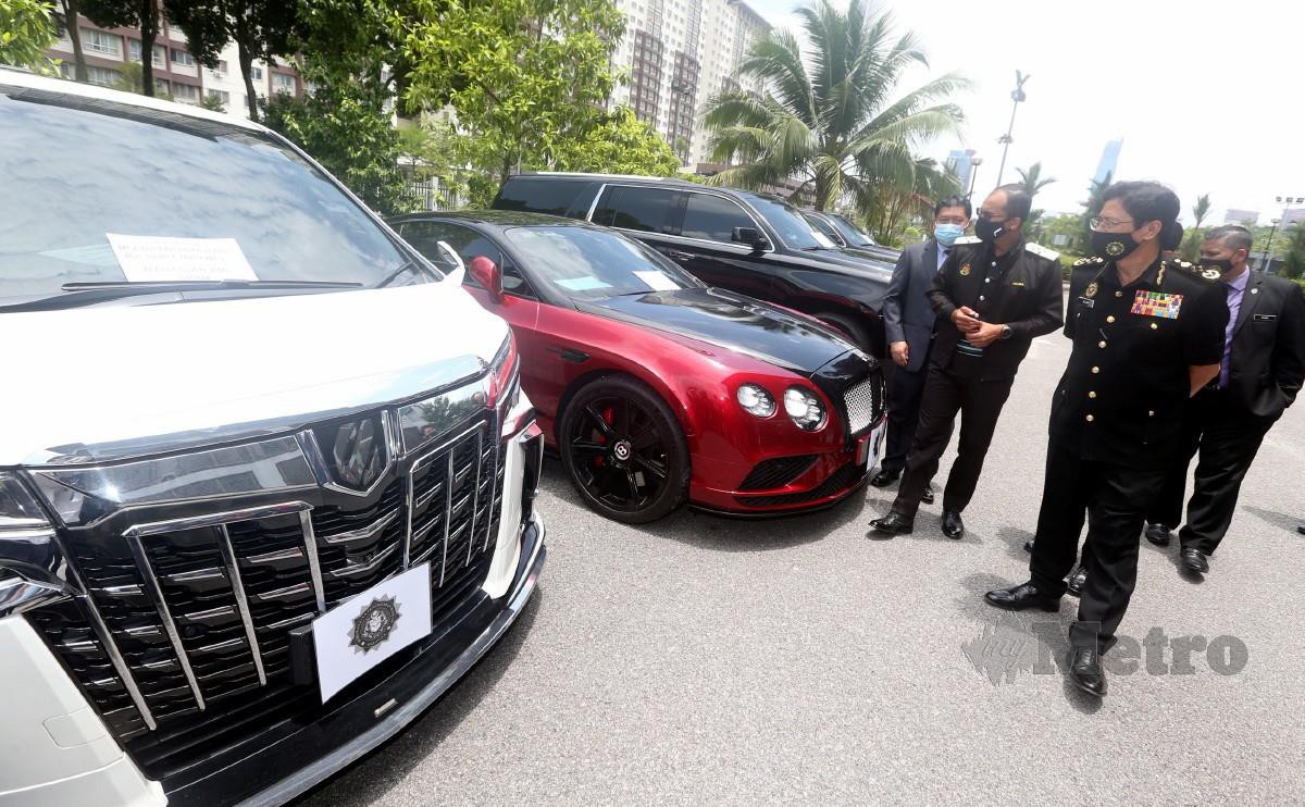 AZAM (dua dari kanan) bersama Khairul Dzaimee  (tiga dari kanan) melihat kenderaan mewah yang dirampas di Pejabat SPRM Kuala Lumpur, semalam.