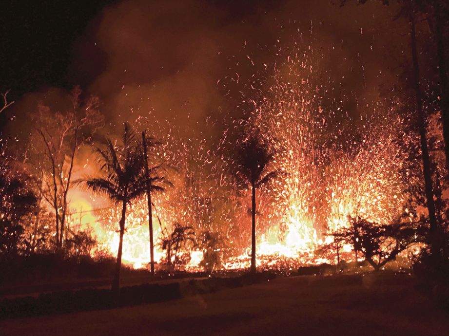 LETUSAN lava setinggi 70 meter dikesan di satu rekahan di Leilani Estates, kesan  letusan gunung berapi Kilauea di Hawaii kelmarin. - AFP