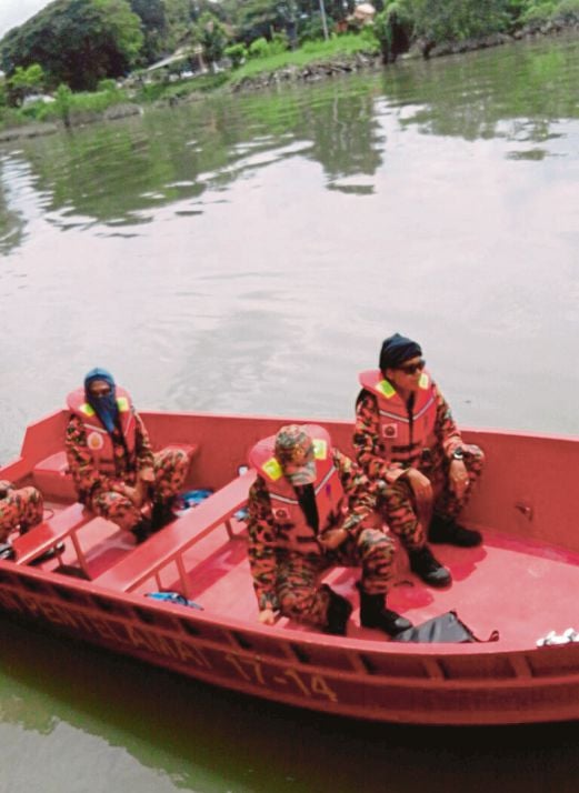 Anggota bomba mencari mangsa yang terjun ke dalam sungai.