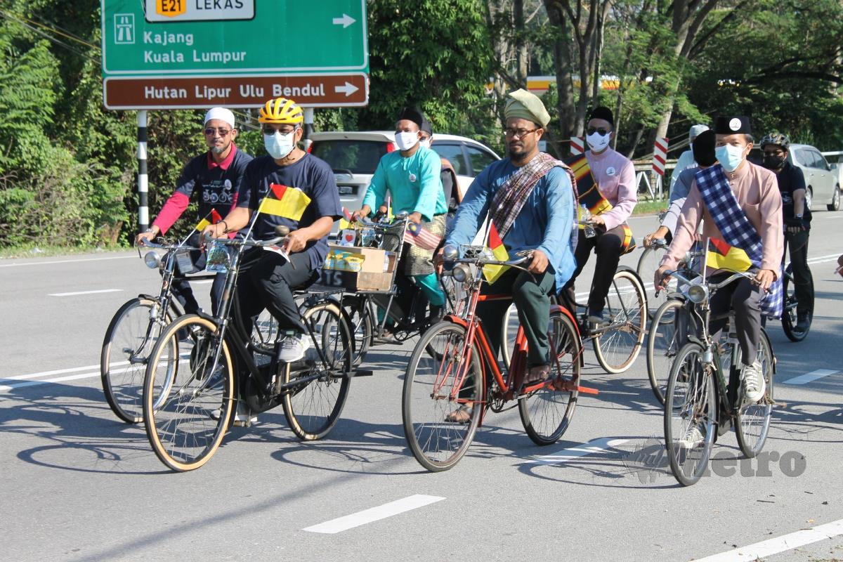 Peminat basikal tua berkayuh sambil berselawat kepada junjungan Nabi SAW pada sambutan Maulidur Rasul di Paroi, hari ini. FOTO Mohd Amin Jalil