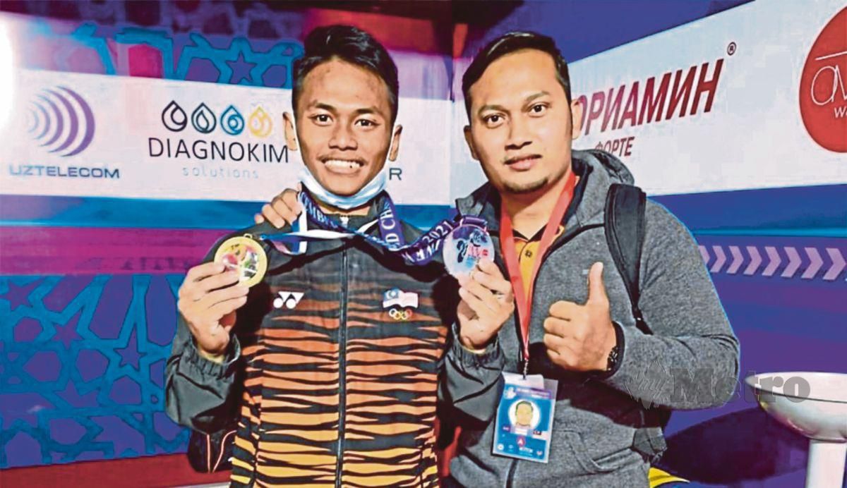 MOHAMAD Aniq Kasdan (kiri) antara atlet angkat berat yang beraksi di Hanoi.
