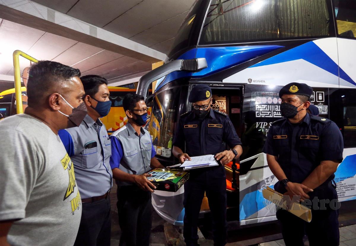 HANIF  (dua dari kanan) melakukan  pemeriksaan terhadap pemandu bas ekspres di Terminal 1, semalam. FOTO AZRUL EDHAM MOHD AMINUDDIN