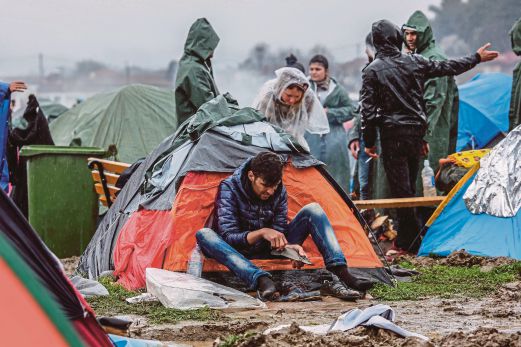 SEORANG lelaki yang terkandas di Idomeni, Greece yang bersempadan dengan Macedonia, duduk di luar khemahnya.