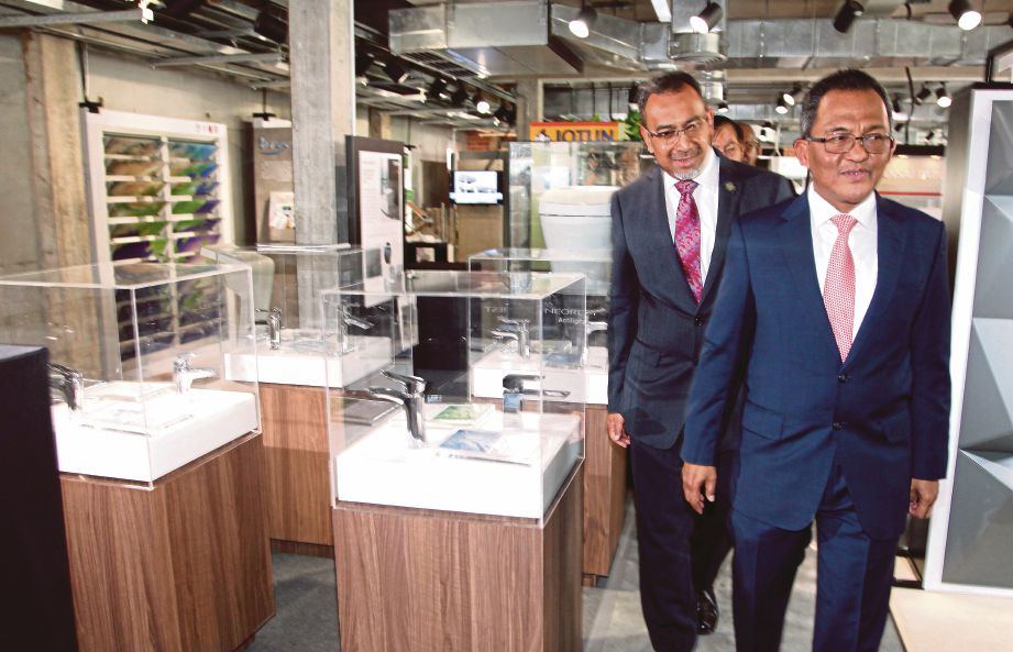 EZUMI   (kiri) mengiringi   Ahmad Asri ketika meninjau bilik pameran PAM  di ibu pejabat PAM,  Bangsar.