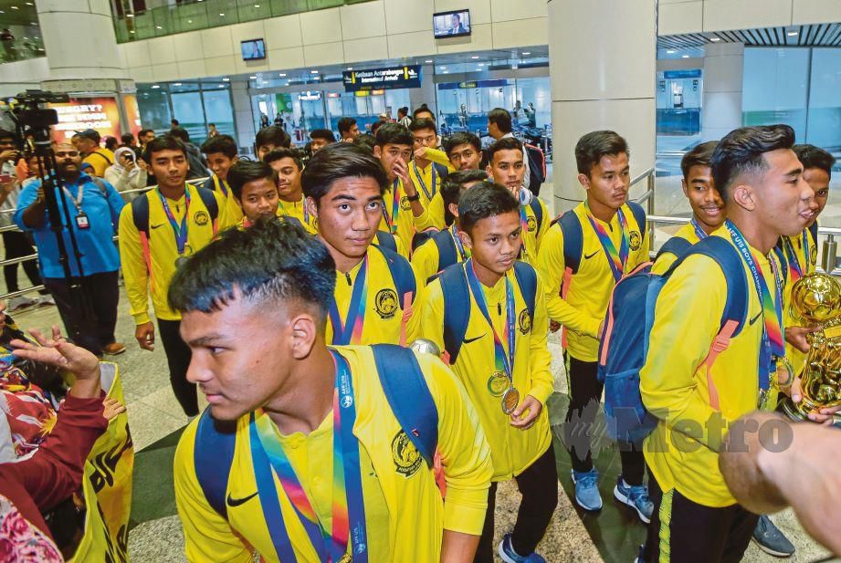 PEMAIN skuad B-15 negara ketika tiba di balai ketibaan KLIA selepas menjuarai Kejuaraan Piala AFF Suzuki B-16 di Chonburi, Thailand. FOTO Luqman Hakim Zubir