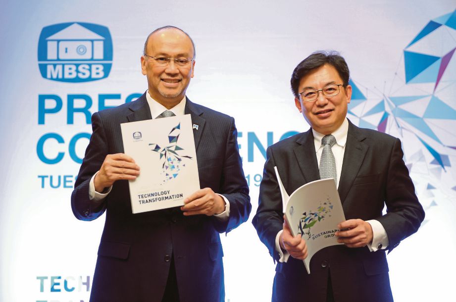 AHMAD Zaini  (kiri) dan Ketua Pegawai Kewangan Tang Yow Sai menunjukkan buku Laporan Tahunan MBSB 2018 sempena Mesyuarat Agung Tahunan MBSB yang ke-49, semalam.