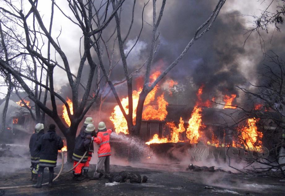 BOMBA memadam kebakaran lori tangki yang meletup selepas terbabas yang turut membunuh puluhan orang di Morogoro. - Reuters