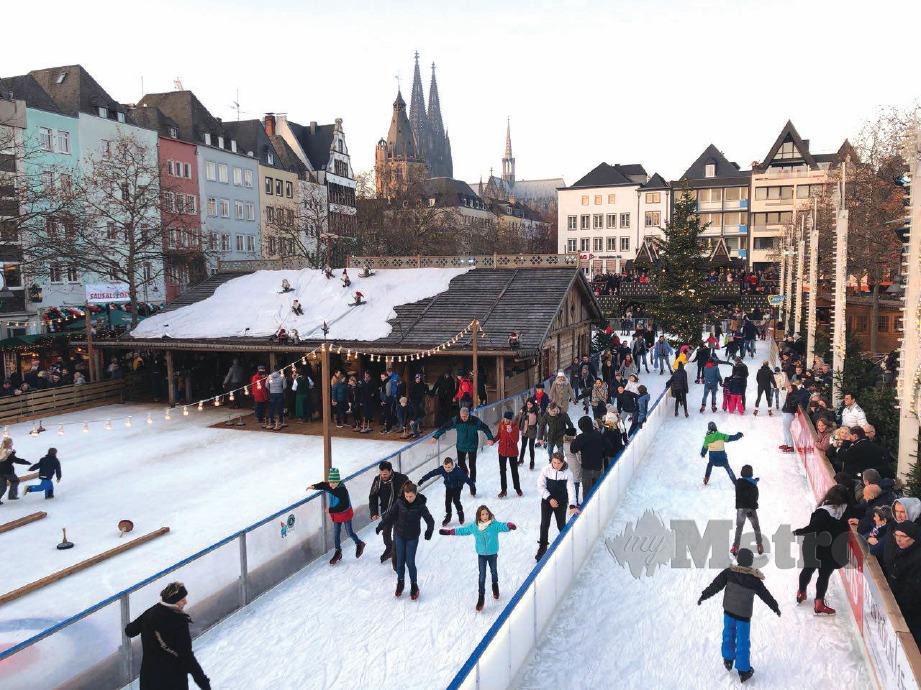 PENDUDUK bermain ski di tapak salji buatan di pinggir kota Cologne. 