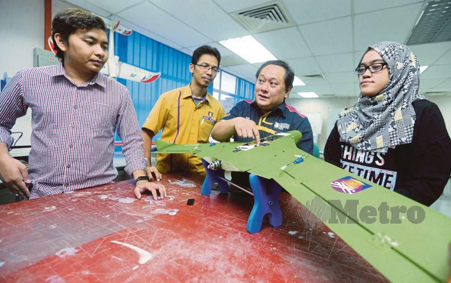 DR Rizal Effendy (dua dari kanan) menerangkan penggunaan dron kepada pelajarnya di makmal penerbangan UiTM Shah Alam.
