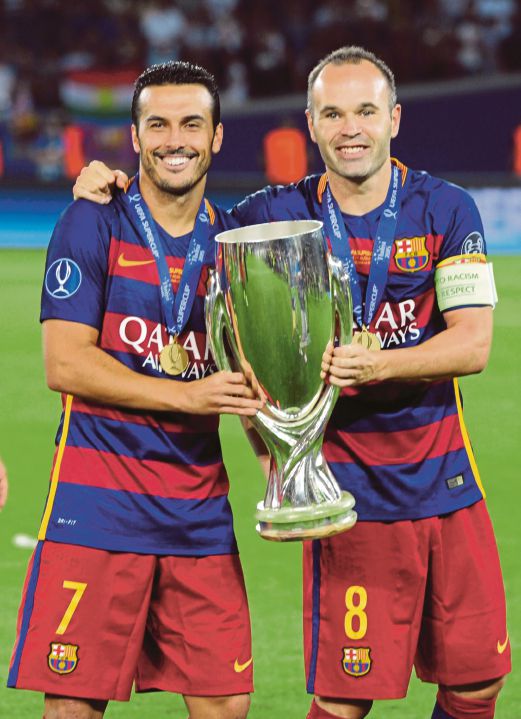PEDRO (kiri) dan Iniesta memperagakan trofi Piala Super Eropah dimenangi Barca.