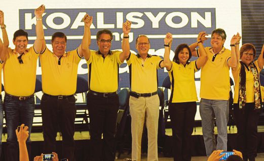 MAR Roxas (tiga dari kiri) dan Leni Robredo (tiga dari kanan) yang akan bertanding untuk jawatan presiden dan naib presiden bersama Aquino (tengah) ketika pendaftaran calon di Manila, semalam.