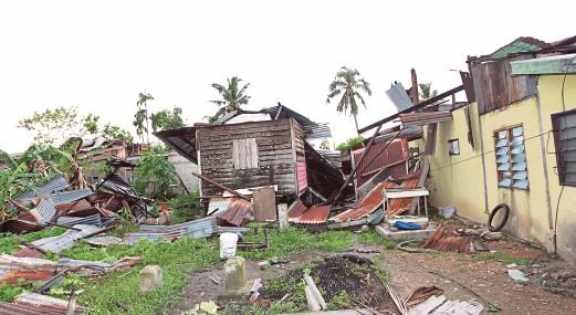 ANTARA rumah di Kampung Sungai Nonang yang rosak angkara puting beliung.