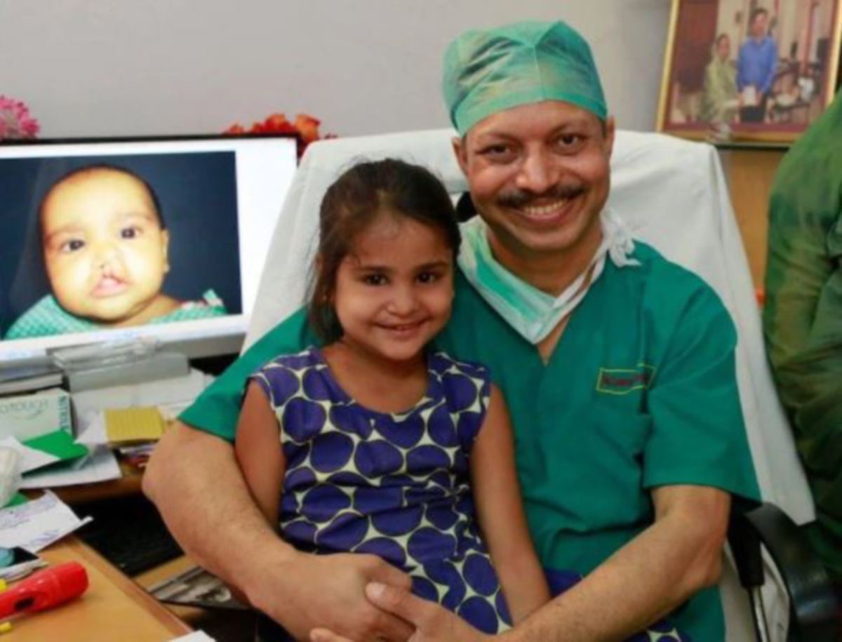 DR SUBODH bersama seorang kanak-kanak yang dirawatnya. FOTO Facebook