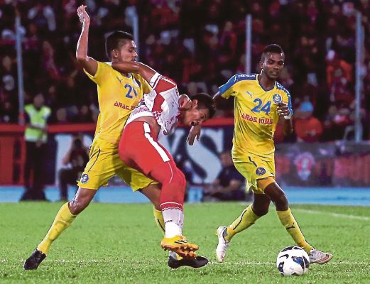 NIK Shahrul (tengah) diasak dua pemain Pahang pada separuh akhir pertama.