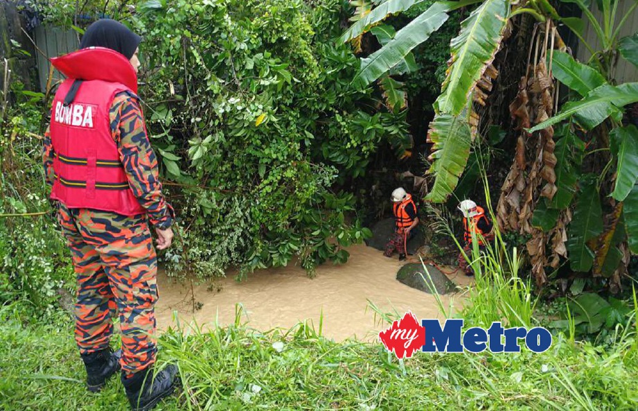 ANGGOTA bomba melakukan operasi mengesan  wanita yang terjatuh ke dalam sungai di Jalan Paya Terubong.