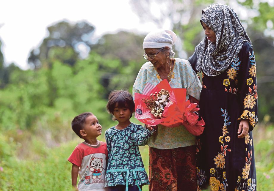 ESHAH (dua dari kanan) menerima jambangan bunga dariipada Hafshah di Kampung Banggol Kemang Serada. 
