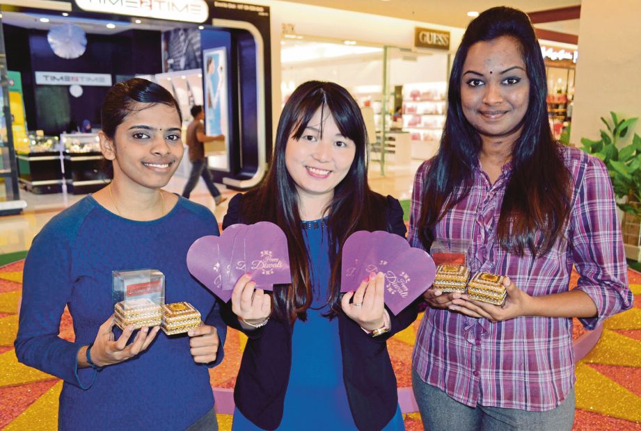 KAKITANGAN SCM menunjukkan sampul Diwali edisi terhad dan kotak barangan kemas di Sunway Carnival Mall, Seberang Jaya. 