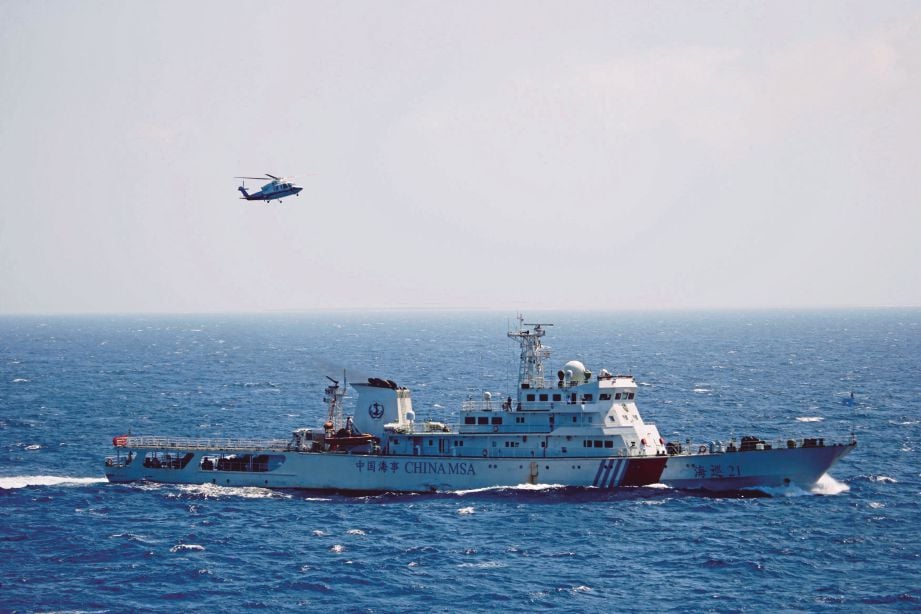 KAPAL perang dan helikopter China dilihat menjalani latihan mencari dan menyelamat berhampiran Kepulauan Paracel di Laut China Selatan, semalam.  - Reuters