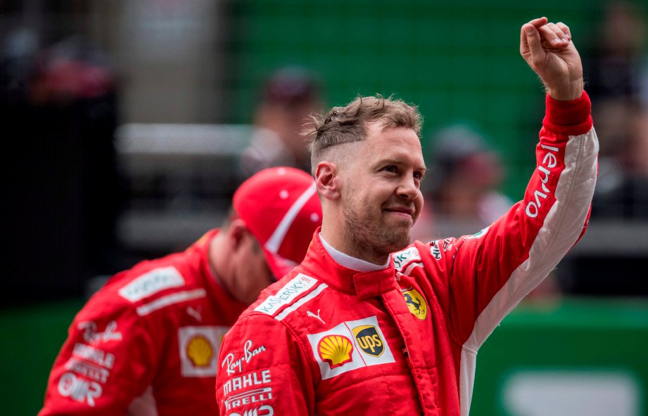 PEMANDU Ferrari, Sebastian Vettel ceria selepas menyambar petak pertama pada GP China, esok. - Foto AFP