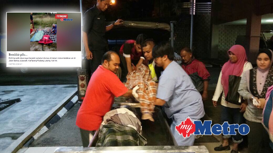 KAKITANGAN Hospital Jempol mengangkat jenazah dua beradik untuk bedah siasat. FOTO Abnor Hamizam Abd Manap