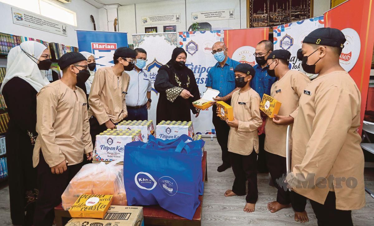 MUHAMAD Safar (lima dari kiri) dan Mohamad Izham (lima dari kanan) menyampaikan sumbangan kepada Pertubuhan Anak Yatim Darul Aminan (Payda) menerusi program Titipan Kasih Harian Metro (TKHM) Bersama Kedai Ayamas.