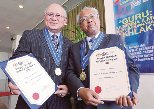 DR Halil (kiri) bersama  Abd Ghafar  menunjukkan  pingat dan sijil diterima.