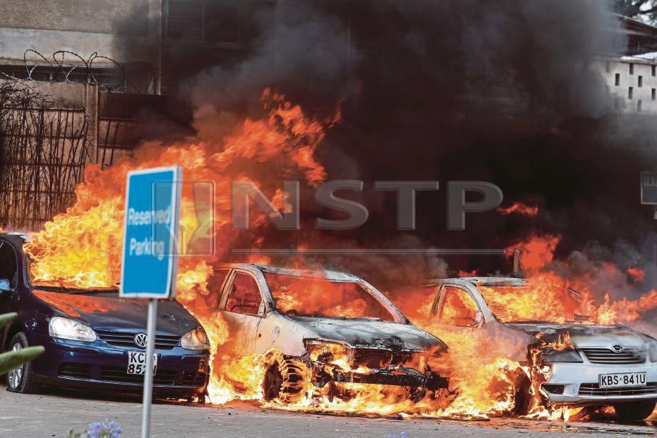 KENDERAAN yang terbakar dalam serangan berkenaan. - Reuters