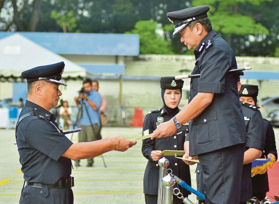  Mazlan  (kanan) menyampaikan sijil penghargaan kepada pegawai pada Majlis Perhimpunan Bulanan Ketua Polis Selangor di Pekarangan Menara 2, IPK Selangor, Shah Alam, semalam.