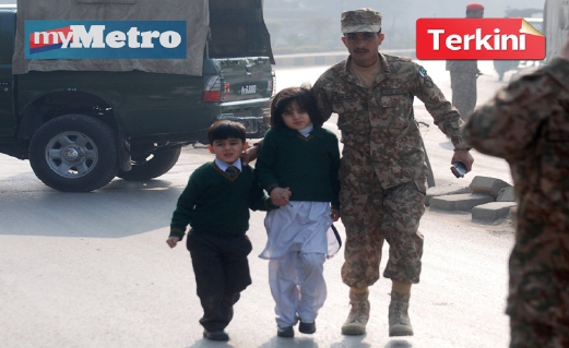 SEORANG askar mengiringi kanak-kanak yang diselamatkan dalam serangan berkenaan. FOTO Reuters