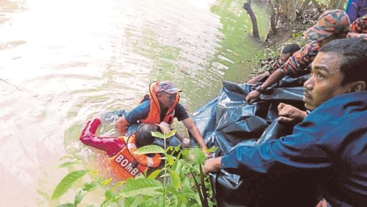 ANGGOTA bomba mengangkat mayat Mohd Sobri yang ditemui di dasar Sungai Bata berhampiran Taman Permai, Bandar Darulaman.