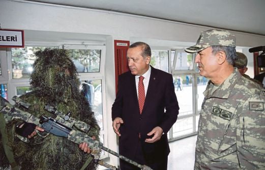 RECEP memeriksa kelengkapan tentera Turki ketika melawat ibu pejabat pasukan Komando negara itu di Ankara, semalam.  