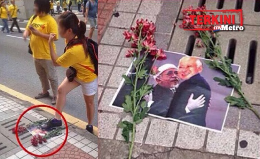 GAMBAR wanita memijak gambar Najib dan Hadi Awang yang menjadi viral di laman sosial.
