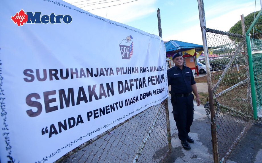 ANGGOTA polis menutup pintu pagar di SK Bumiputera menandakan tamatnya tempoh mengundi bagi Pilihan Raya Kecil DUN Tanjong Datu. FOTO Luqman Hakim