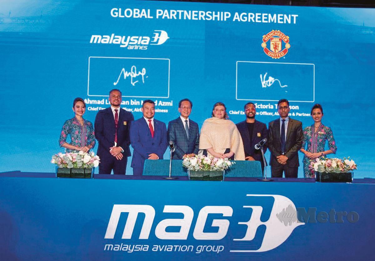 IZHAM (empat dari kiri) bersama Victoria  (empat dari kanan) pada majlis menandatangani perkongsian di antara Malaysia Airlines dengan Manchester United di Kuala Lumpur, semalam. 