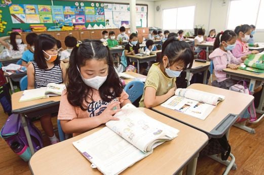 MURID sekolah rendah memakai topeng muka sebagai langkah berjaga-jaga selepas bangunan di Busan itu dibuka semula, semalam.