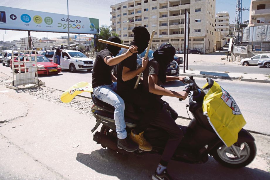 AKTIVIS Palestin meronda bandar Baitullaham untuk memastikan mogok umum dipatuhi.  - AFP 